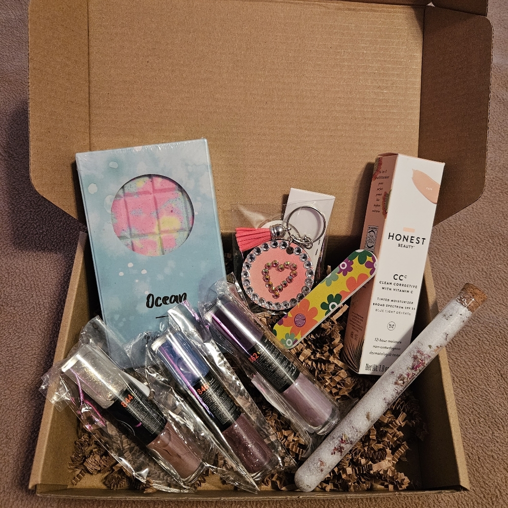 Minimalist Happy Box with bath bomb, tinted moisturizer, nail polishes and more.
